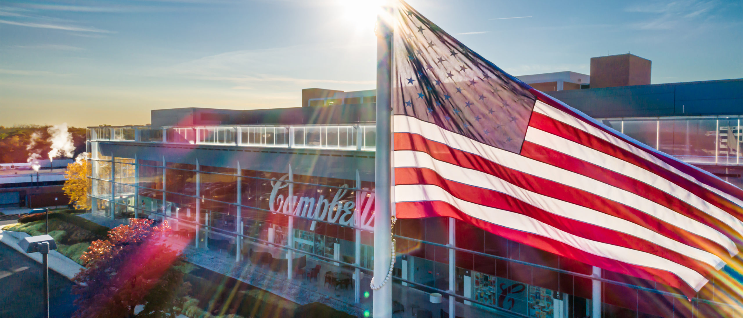 american flag in front of campbell soup company headquarters in camden, new jersey
