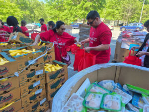 Volunteers load up bags for local families at the Second Harvest Food Bank of Metrolina hosted mobile food pantry.