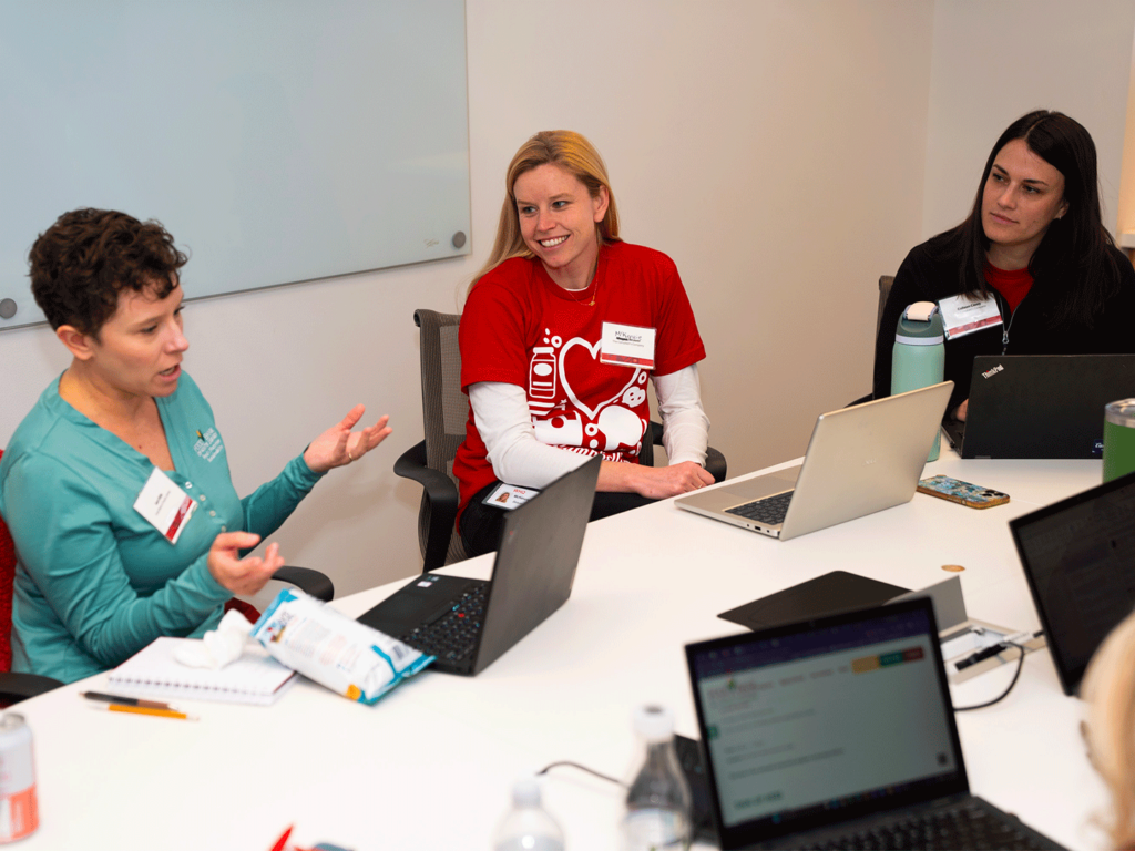 Campbell's employee volunteers brainstorm with a Food Bank of South Jersey staff member