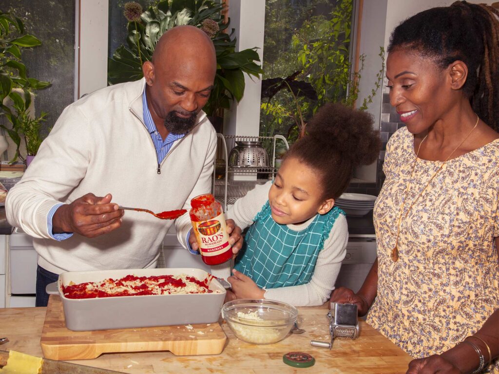 Family cooking dinner using Rao's pasta sauce.