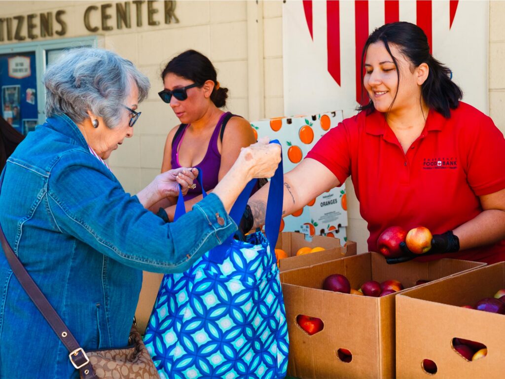 Grant recipient distributing fresh produce.